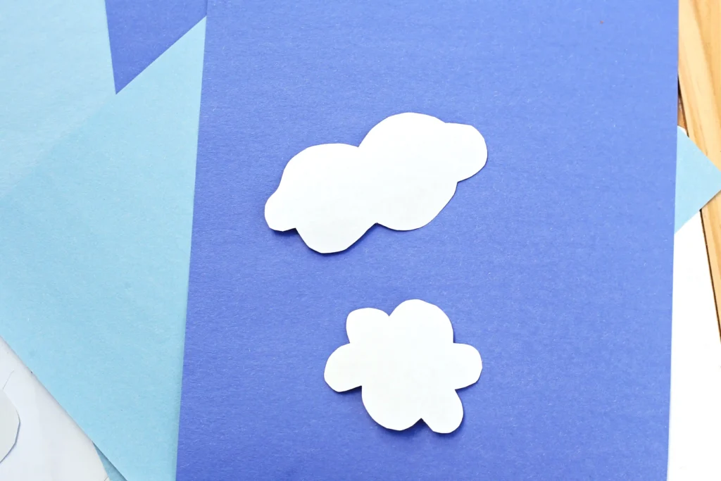 clouds cut out of white construction paper for this r is for rain paper craft
