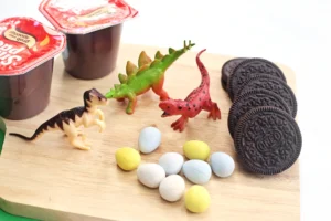 chocolate pudding cups, oreos, robins eggs, and toy dinosaurs