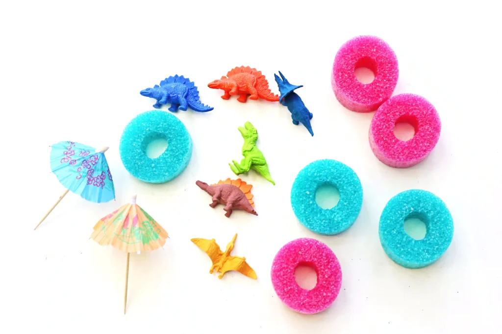 slices of pool noodles, toy dinosaurs, and drink umbrellas