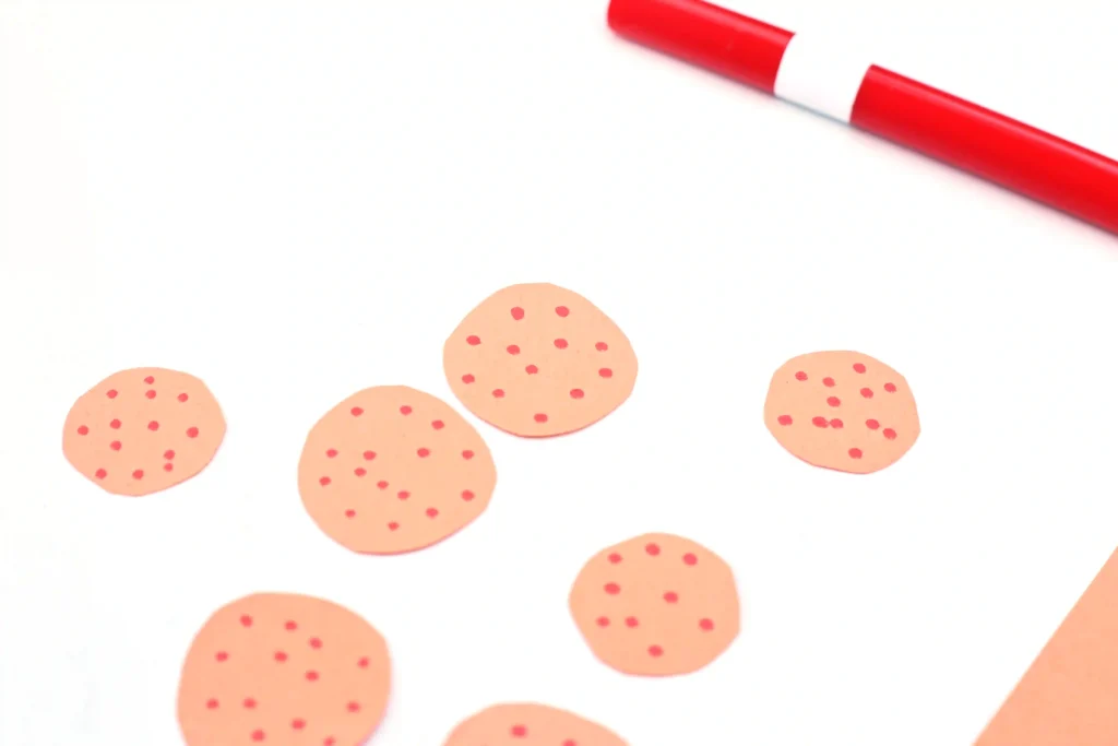 Letter P Pizza Craft - Cultivating Brilliant Minds orange paper cut into circles with red dots drawn on to be pepperoni for this pizza craft for kids
