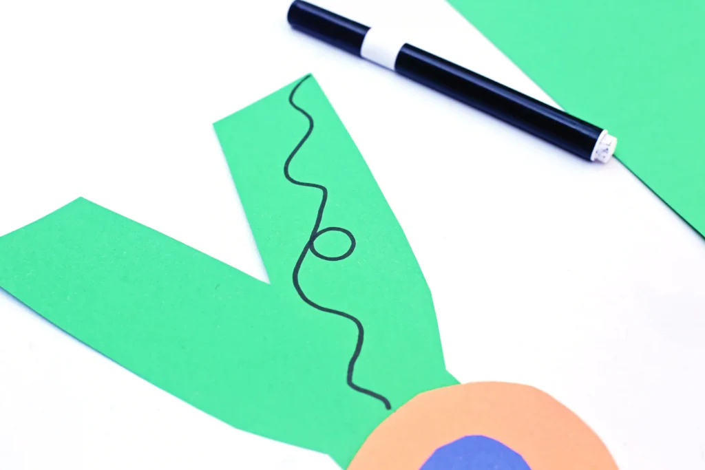a letter y cut out of green construction paper with an orange and blue circle glued on and a string drawn on to look like a yo-yo