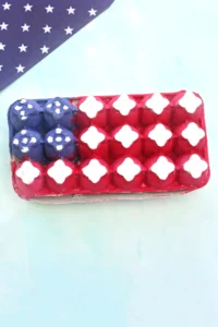 a patriotic craft that uses an egg carton and paints it to look like the american flag to create a fourth of july recycled craft