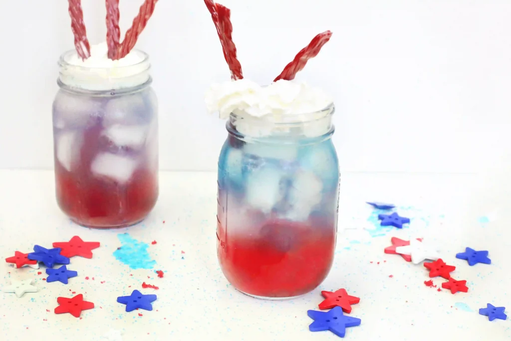 a red, white, and blue drink with whipped cream and twizzlers