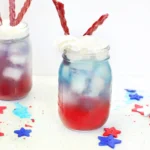a red, white, and blue drink with whipped cream and twizzlers