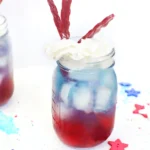 a red, white, and blue drink with whipped cream and twizzlers