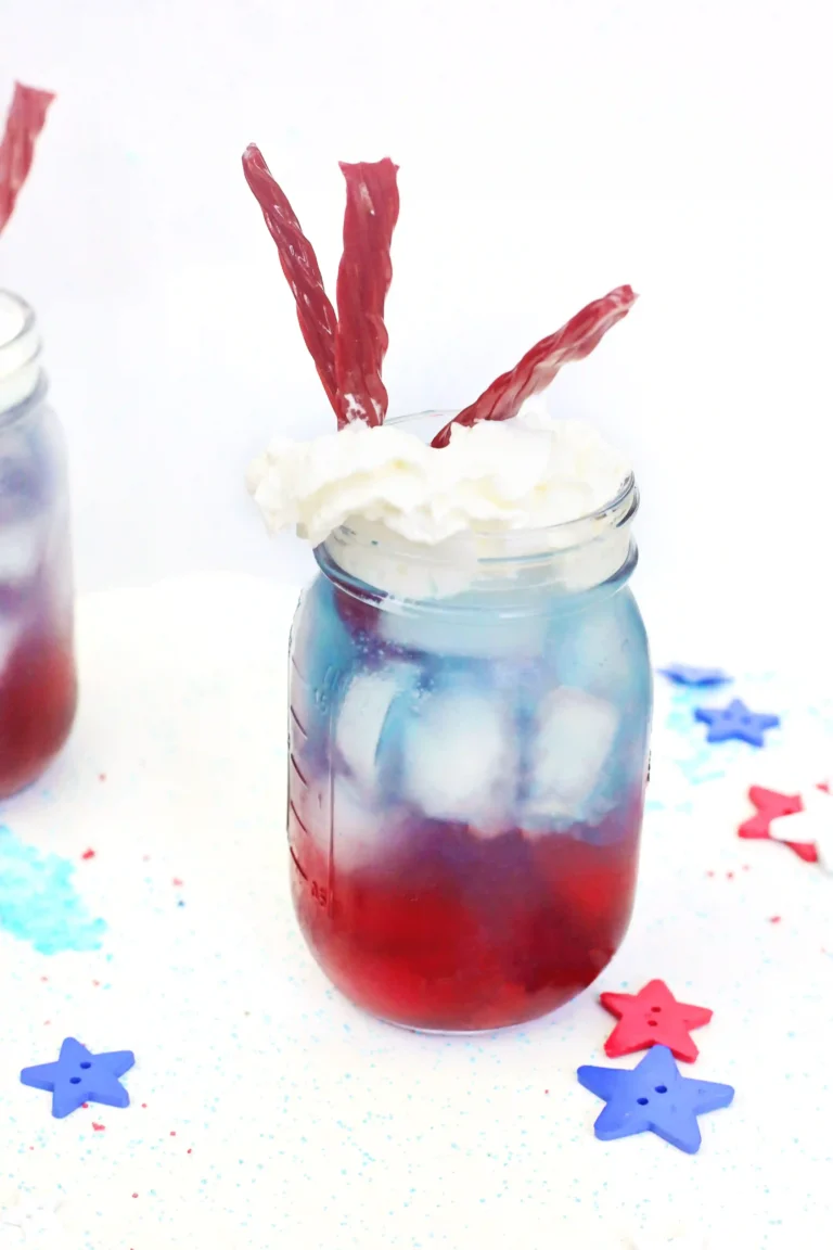 a red, white, and blue drink with whipped cream and twizzlers