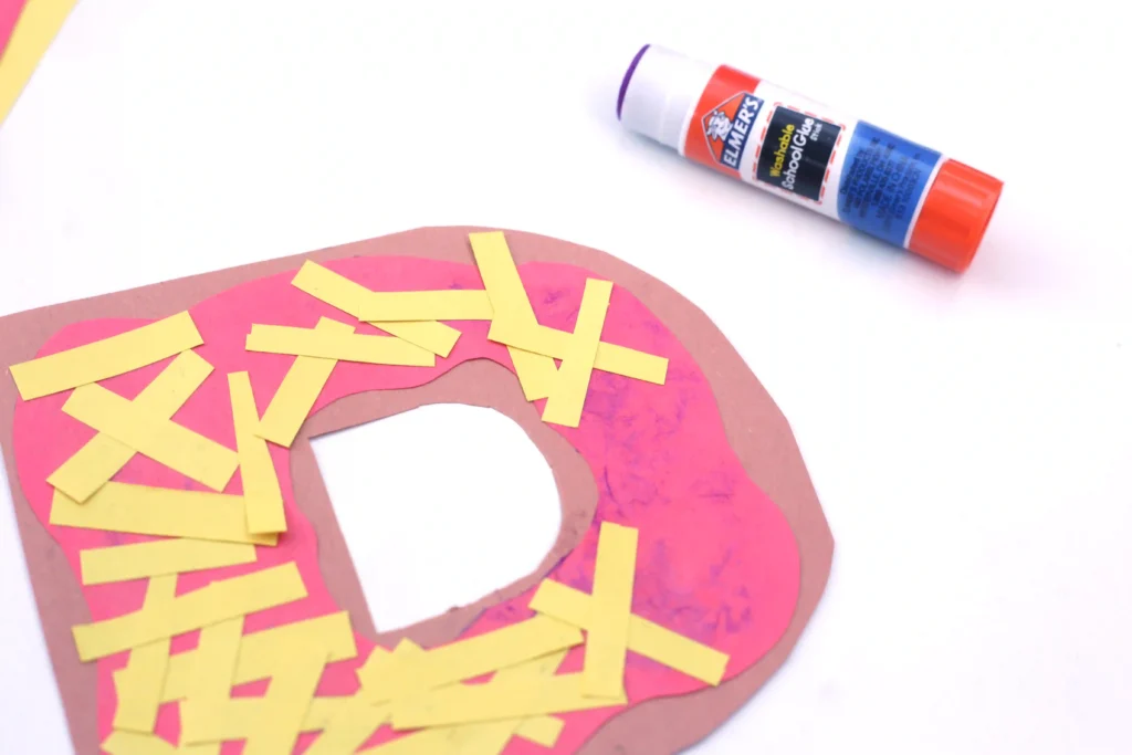Letter P Pizza Craft - Cultivating Brilliant Minds a letter p cut out of construction paper with yellow strips of paper on top to be cheese