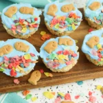 fish bowl rice krispie treats with goldfish crackers and fruity pebbles on a wooden cutting board