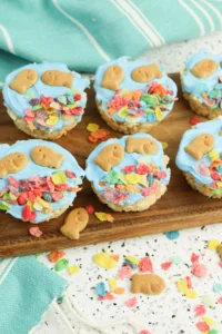 fish bowl rice krispie treats with goldfish crackers and fruity pebbles on a wooden cutting board