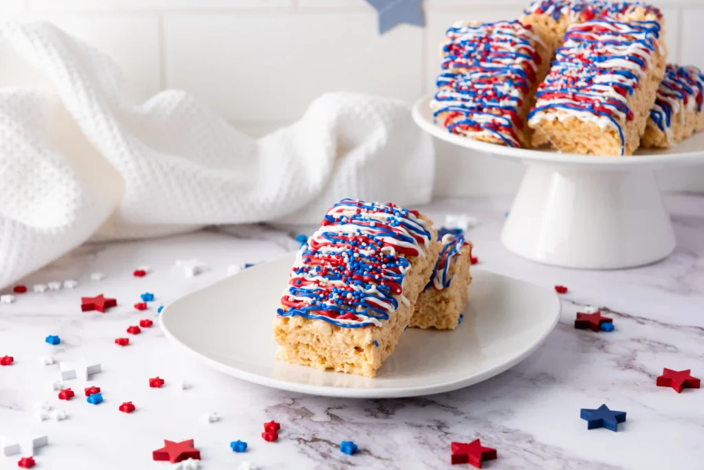 rice krispie treats with red, white, and blue chocolate and sprinkles on top