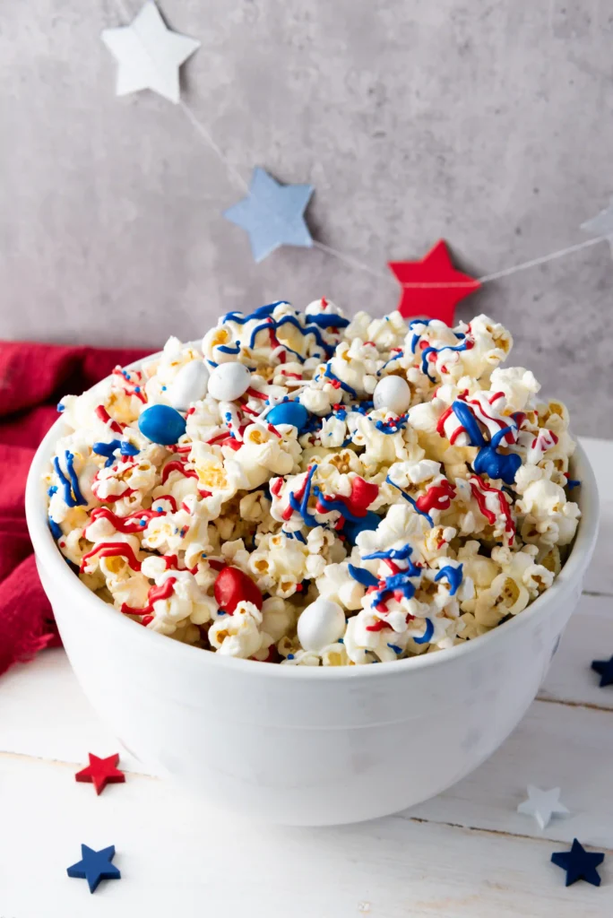 Patriotic Popcorn - Cultivating Brilliant Minds patriotic popcorn with red, white, and blue sprinkles, chocolate, and m&ms
