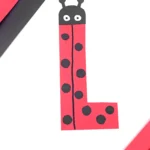 construction paper cut to look like the letter l and decorated like a ladybug