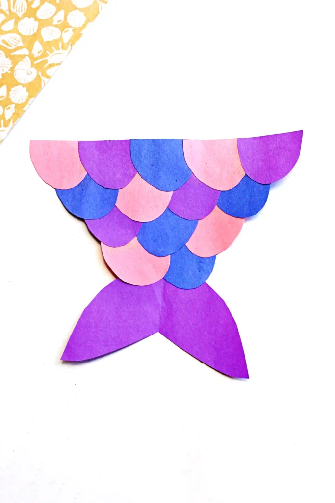 a mermaid tail craft made out of pink, purple, and blue construction paper