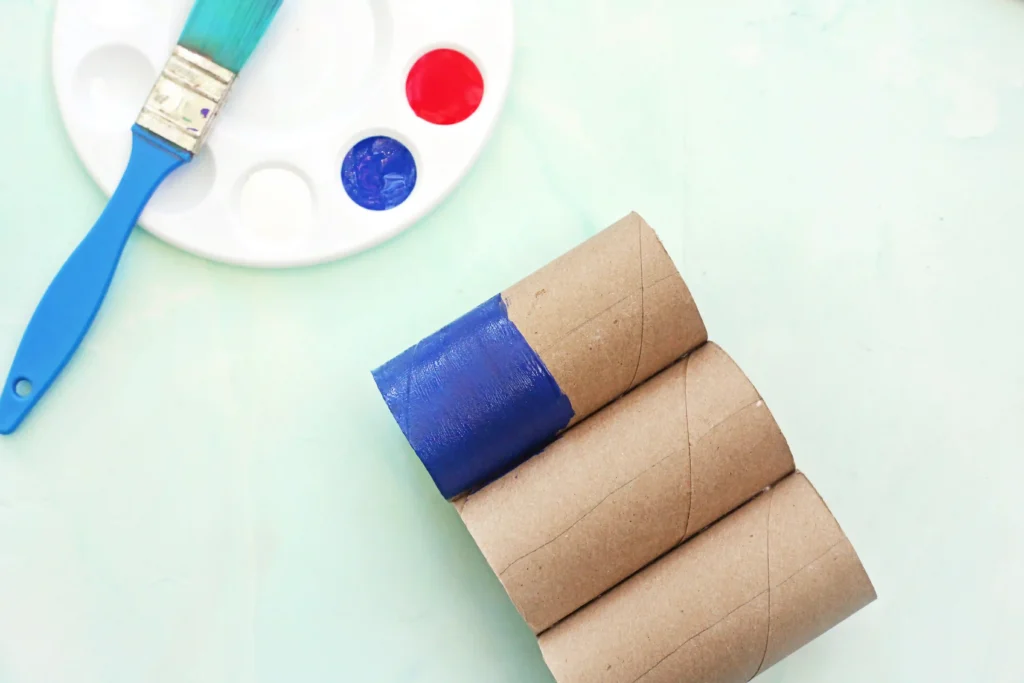 Toilet Paper Roll American Flag - Cultivating Brilliant Minds three toilet paper rolls glued together with the top left half of the first tube painted blue