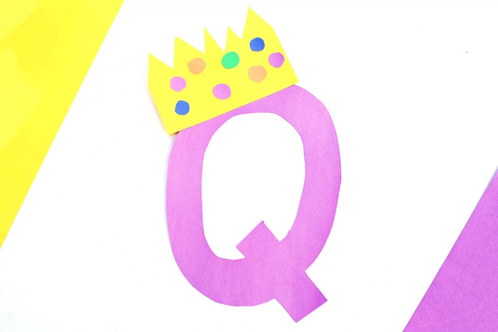 Letter Q Queen Craft - Cultivating Brilliant Minds a letter q cut out of purple construction paper with a construction paper crown on top