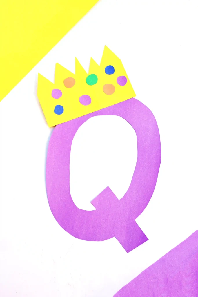 Letter Q Queen Craft - Cultivating Brilliant Minds a letter q cut out of purple construction paper with a construction paper crown on top