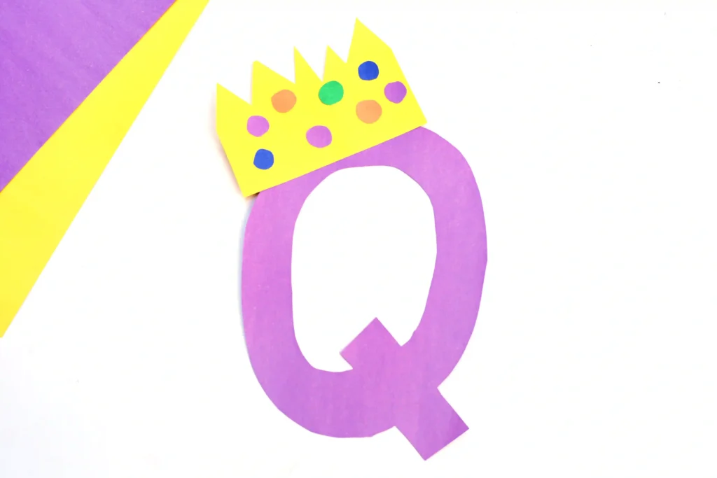 Letter Q Queen Craft - Cultivating Brilliant Minds a letter q cut out of purple construction paper with a construction paper crown on top