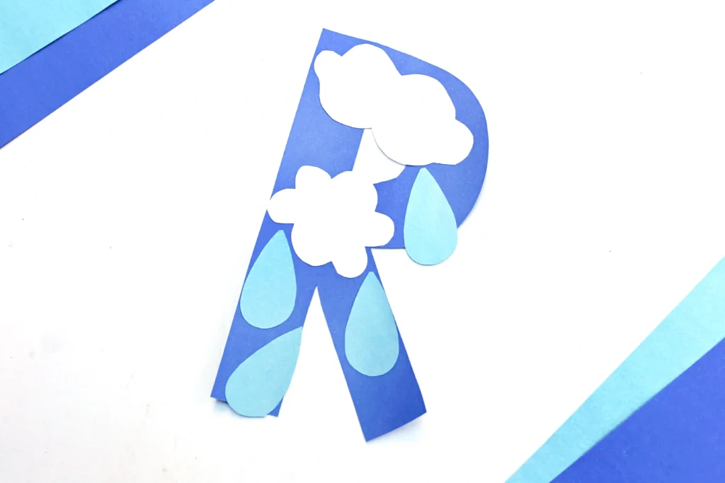 letter r craft cut out of blue construction paper with rain drops and clouds