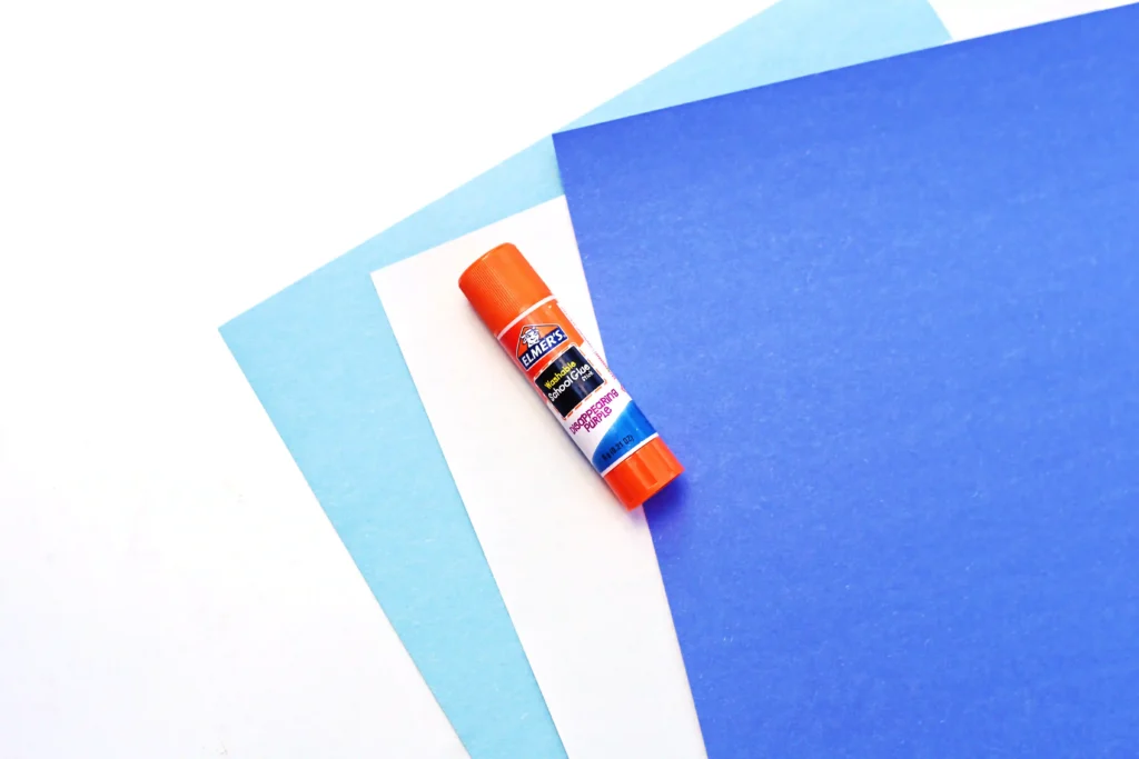 light blue, white, and dark blue construction paper and a glue stick