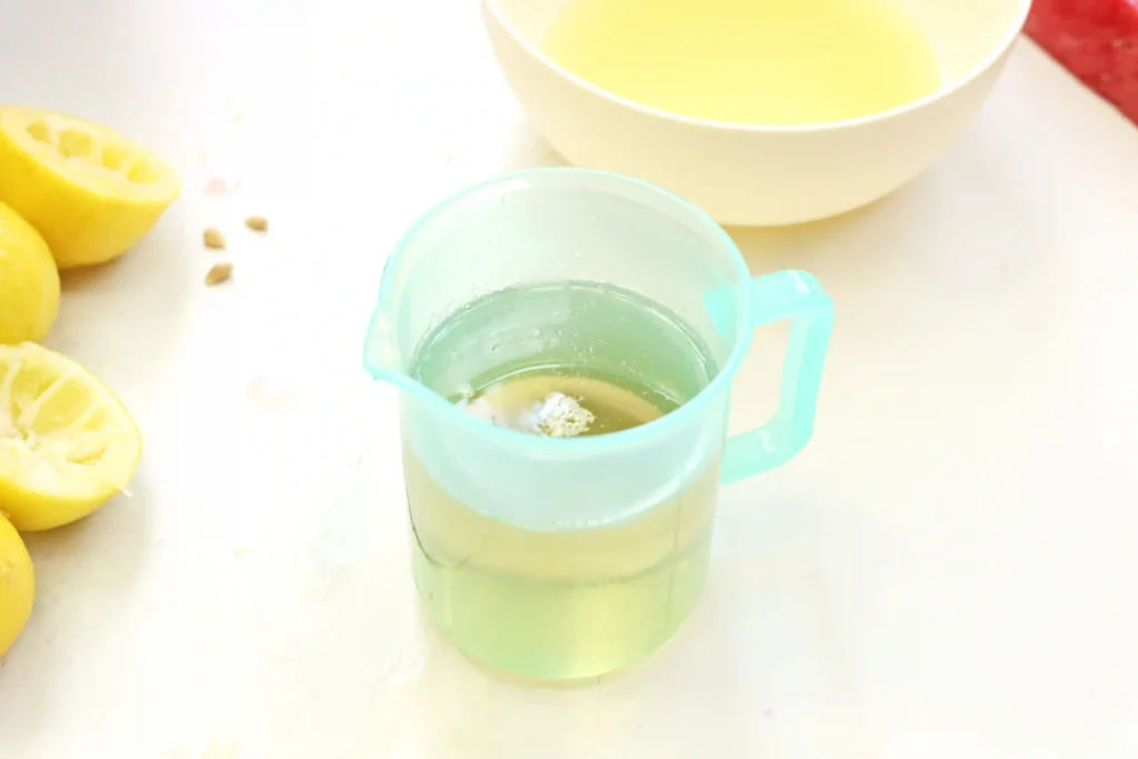 simple syrup in a measuring cup