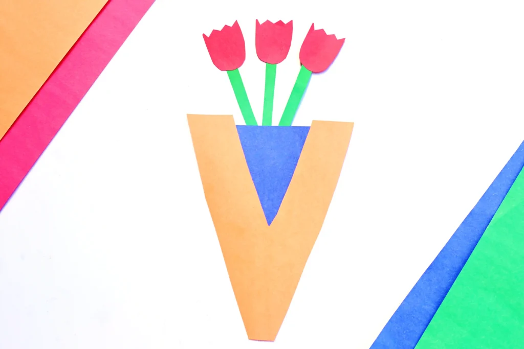 a letter v vase craft made out of construction paper with paper roses inside
