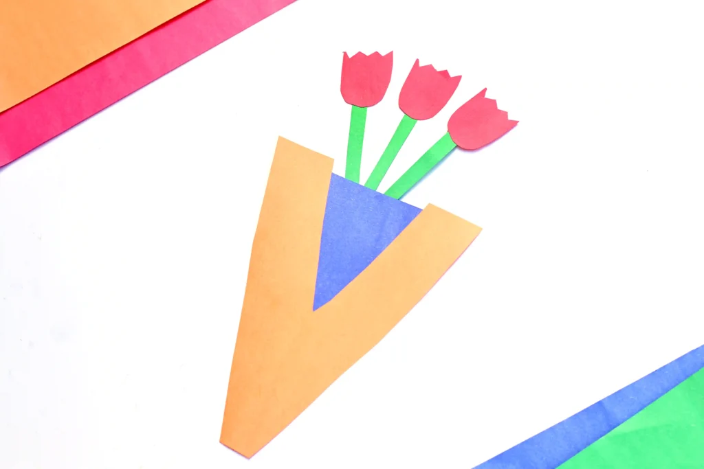 a preschool letter v vase activity craft made out of construction paper with paper roses inside