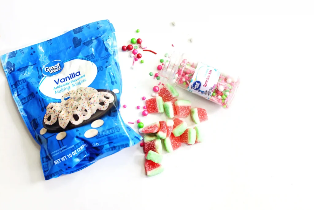 ingredients for the watermelon chocolate bark - white candy melts, watermelon gummies, and watermelon-themed sprinkles