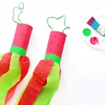 a watermelon windsock that has a toilet paper roll painted like toa watermelon and red and green streamers