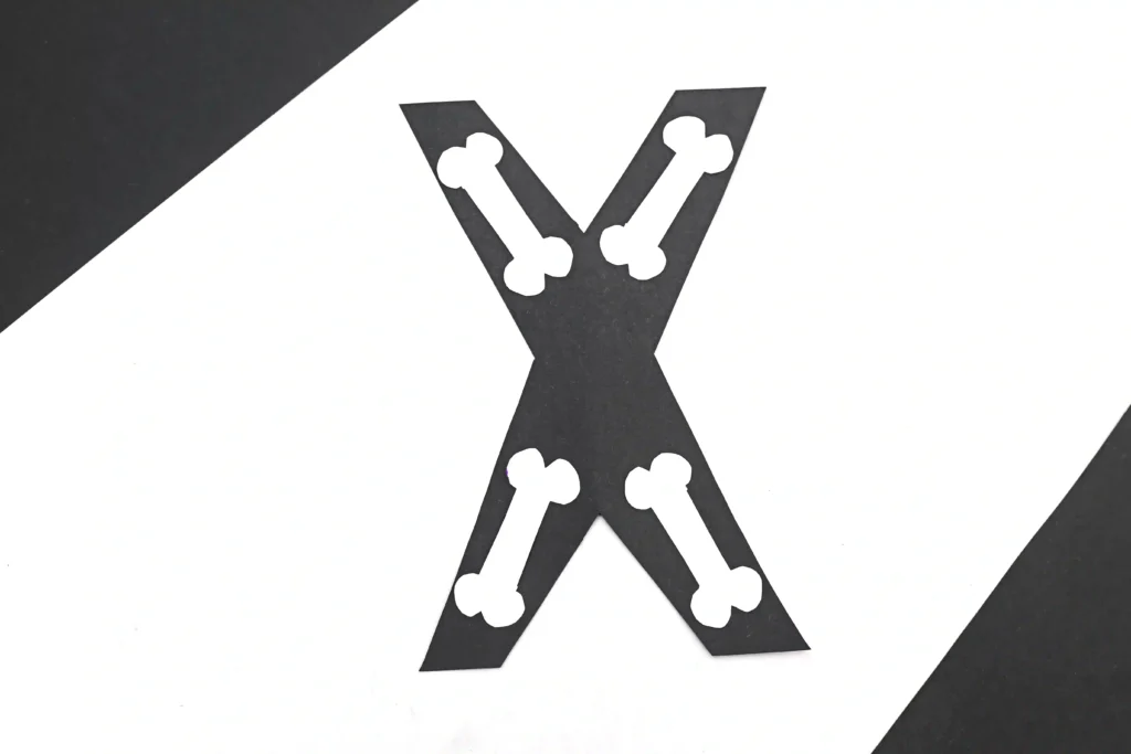 a letter x craft that has a black x with white bones to look like an x-ray