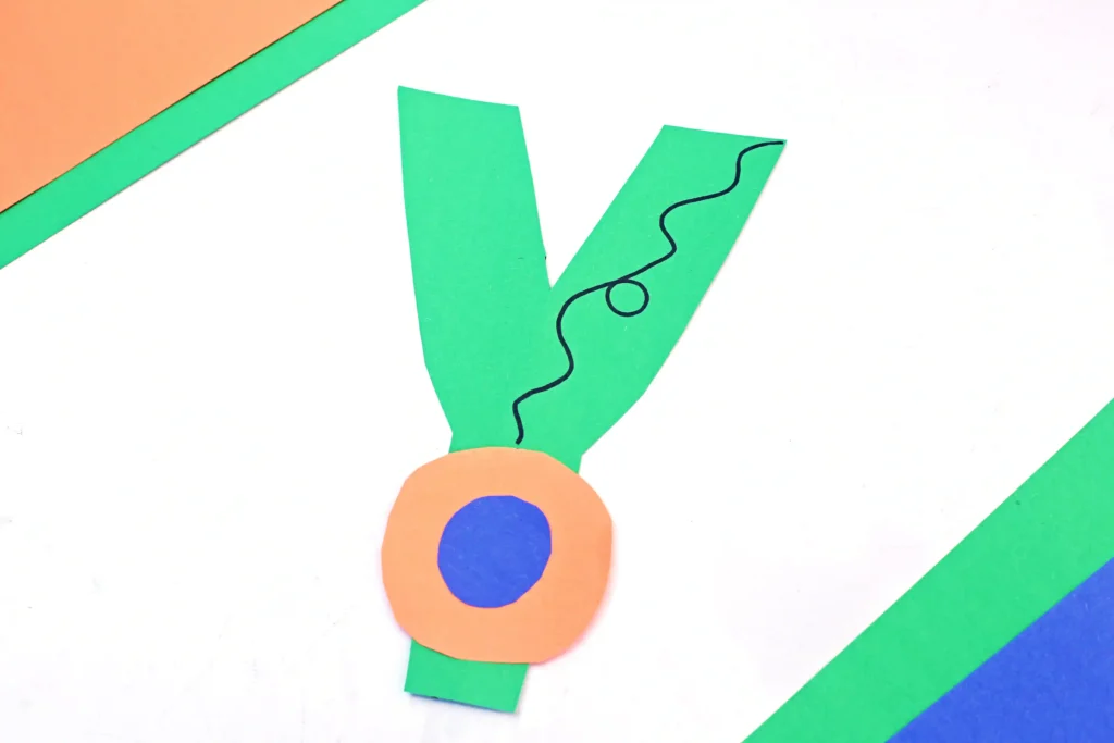 a letter y craft that has a letter y cut out of green construction paper and a construction paper yoyo attached
