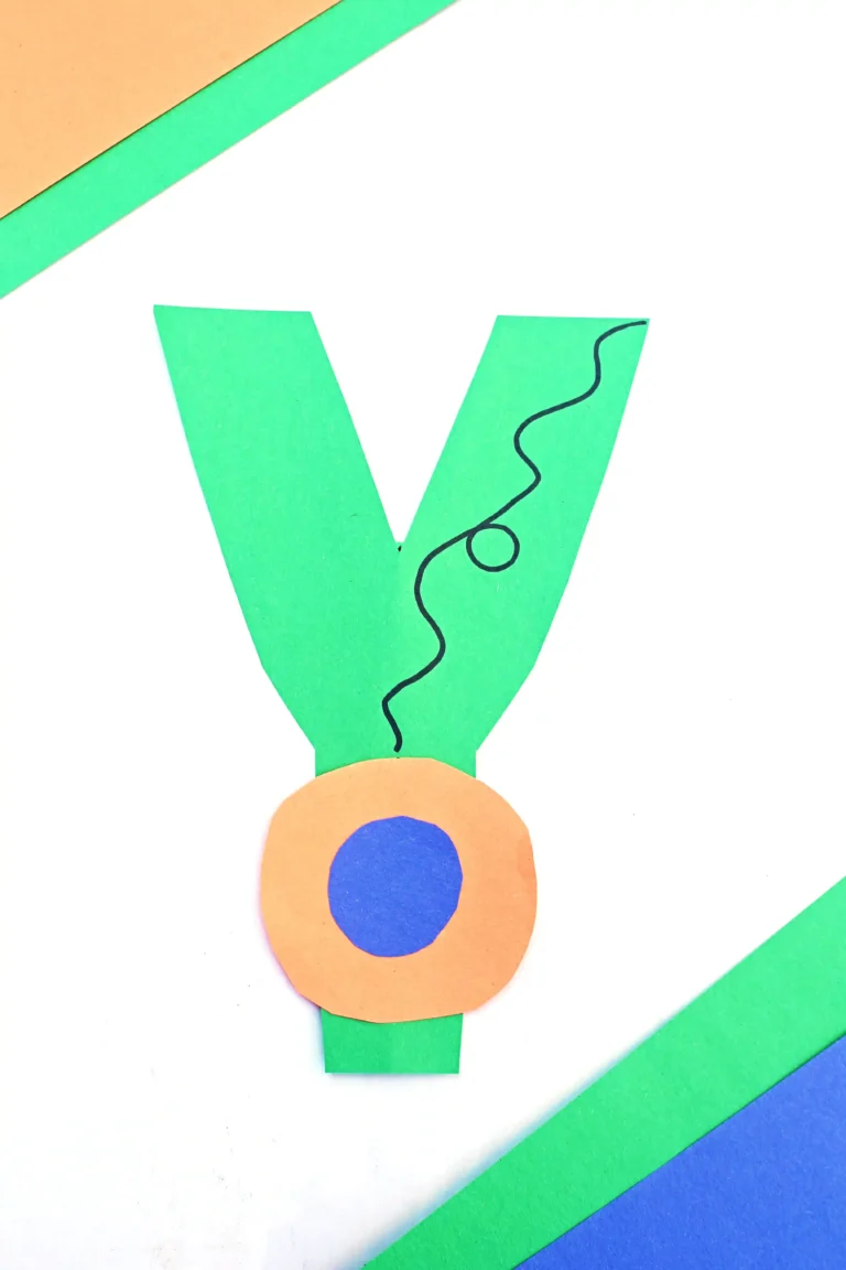 a letter y craft that has a letter y cut out of green construction paper and a construction paper yoyo attached