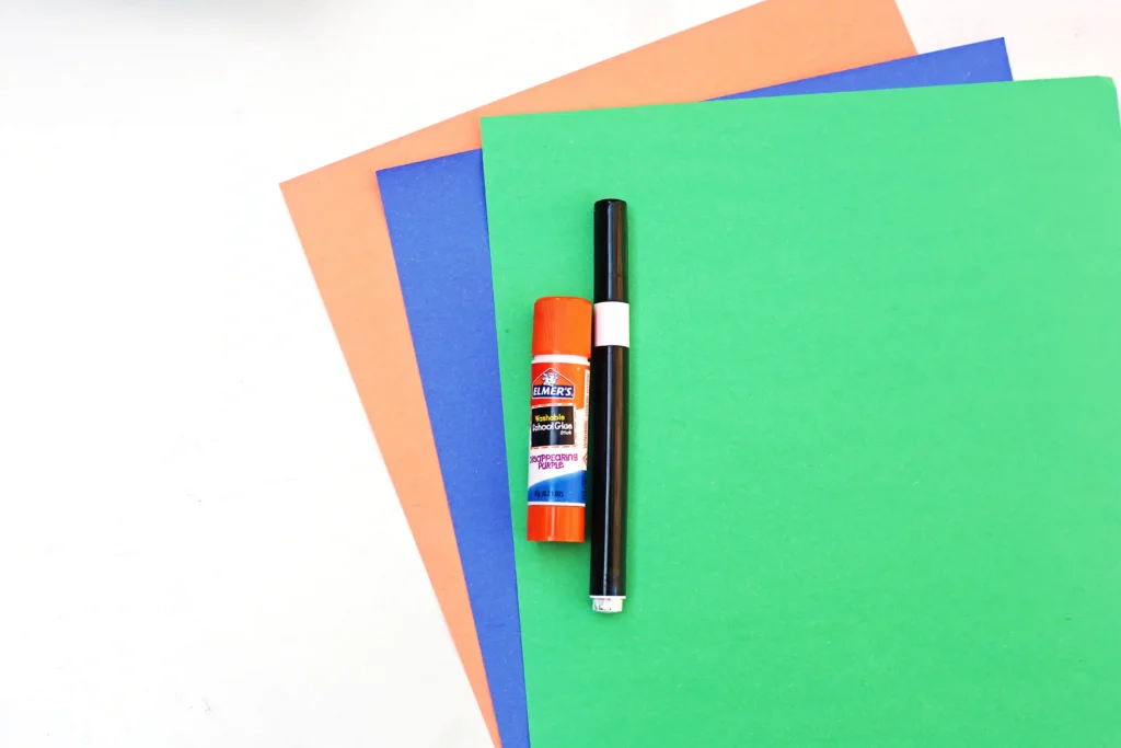 supplies for this y is for yo-yo paper craft - orange, green, and blue construction paper, a black marker, and a glue stick