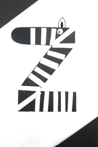 a letter z craft that is a letter z cut out of black construction paper with white stripes