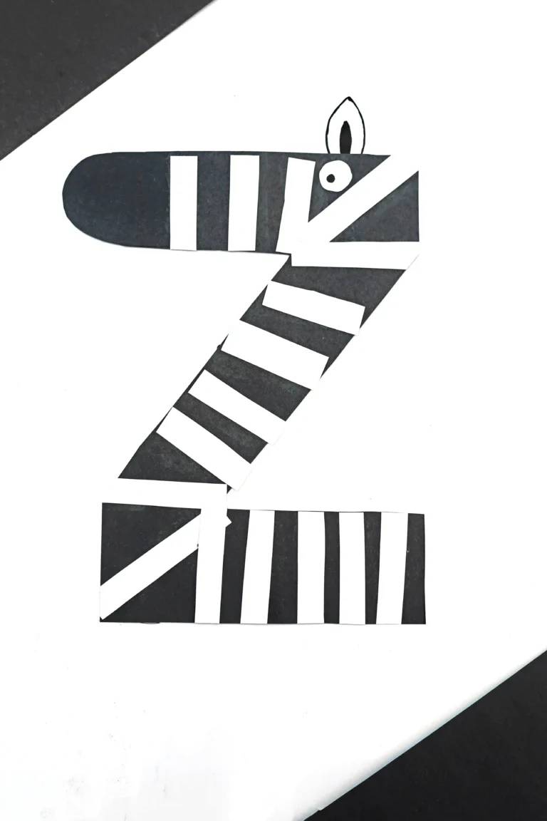 a letter z craft that is a letter z cut out of black construction paper with white stripes