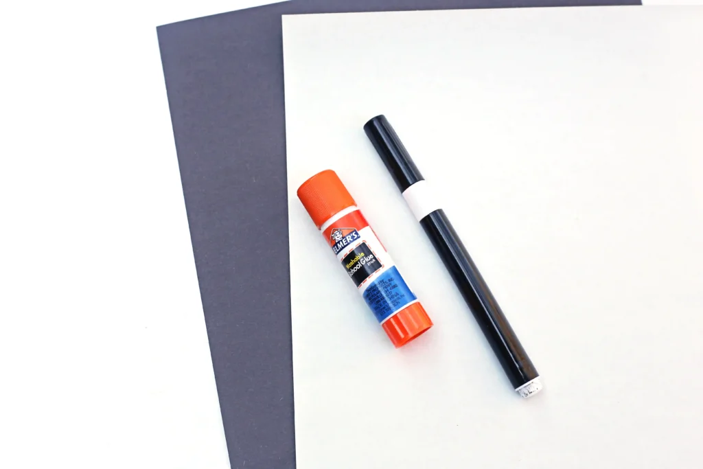 supplies for this z is for zebra paper craft - black and white construction paper, a black marker, and a glue stick