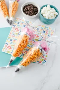 Pencil Treat Bags that are stuffed with kid-friendly snacks and candy in the color order to look like a pencil for these teacher appreciation gifts