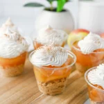 mini dessert cups with a graham cracker crust, apple pie filling, and cool whip on top