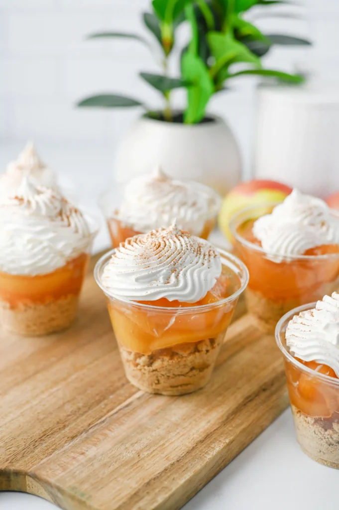 Apple Pie In A Cup - Cultivating Brilliant Minds mini dessert cups with a graham cracker crust, apple pie filling, and cool whip on top