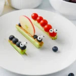 celery bug snacks with peanut butter and various fruits and veggies to look like bugs