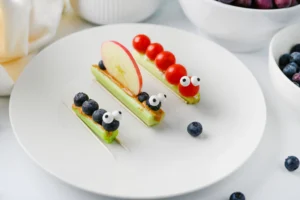 celery bug snacks with peanut butter and various fruits and veggies to look like bugs