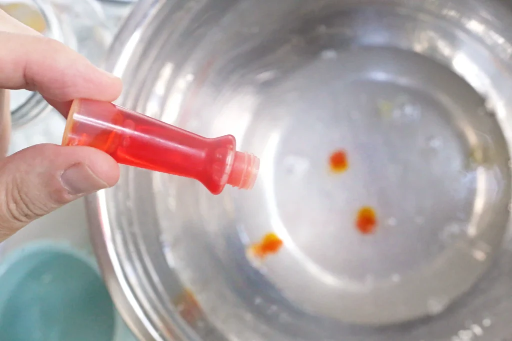 Lemon Slime - Cultivating Brilliant Minds clear glue, lemon, and yellow food coloring in a bowl