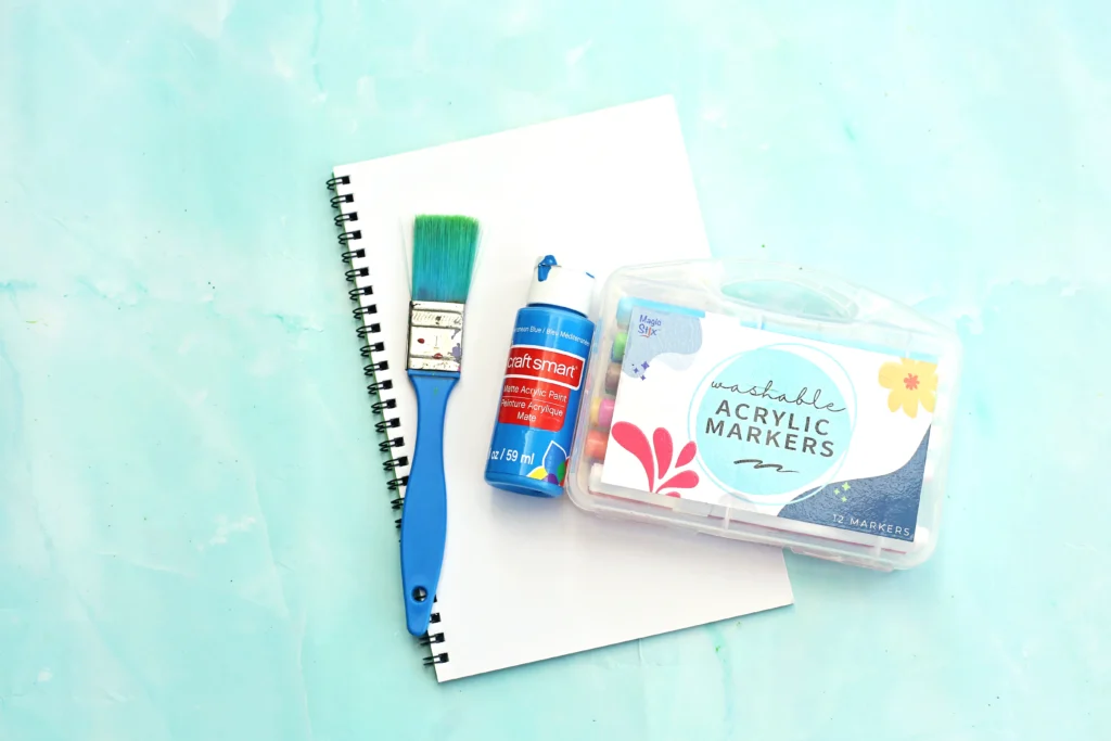supplies for this b is for bird handprint craft- paper, blue paint, paintbrush, and markers