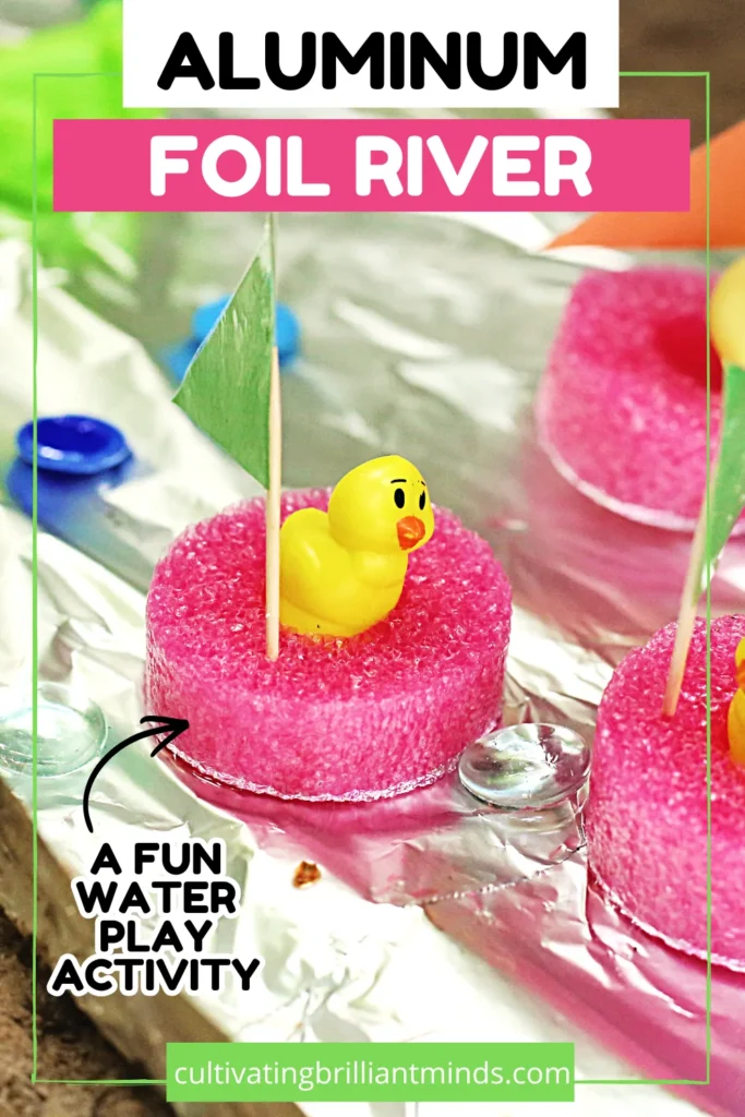 Aluminum Foil River - Cultivating Brilliant Minds aluminum foil river with pink pool noodle slices, a yellow rubber duck, and colorful paper flags on the ground