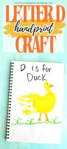 Notebook page with handwriting 'D is for Duck' beside a yellow duck illustration on green grass and a turquoise background.