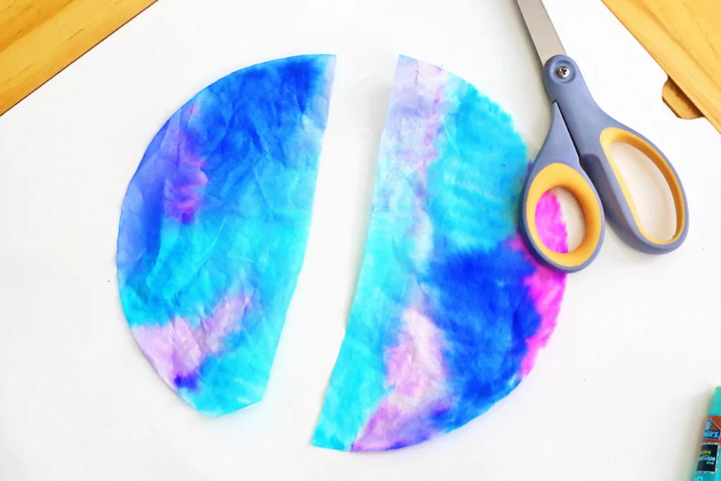 Coffee Filter Jellyfish Craft - Cultivating Brilliant Minds colored coffee filters cut in half for this ocean animal craft