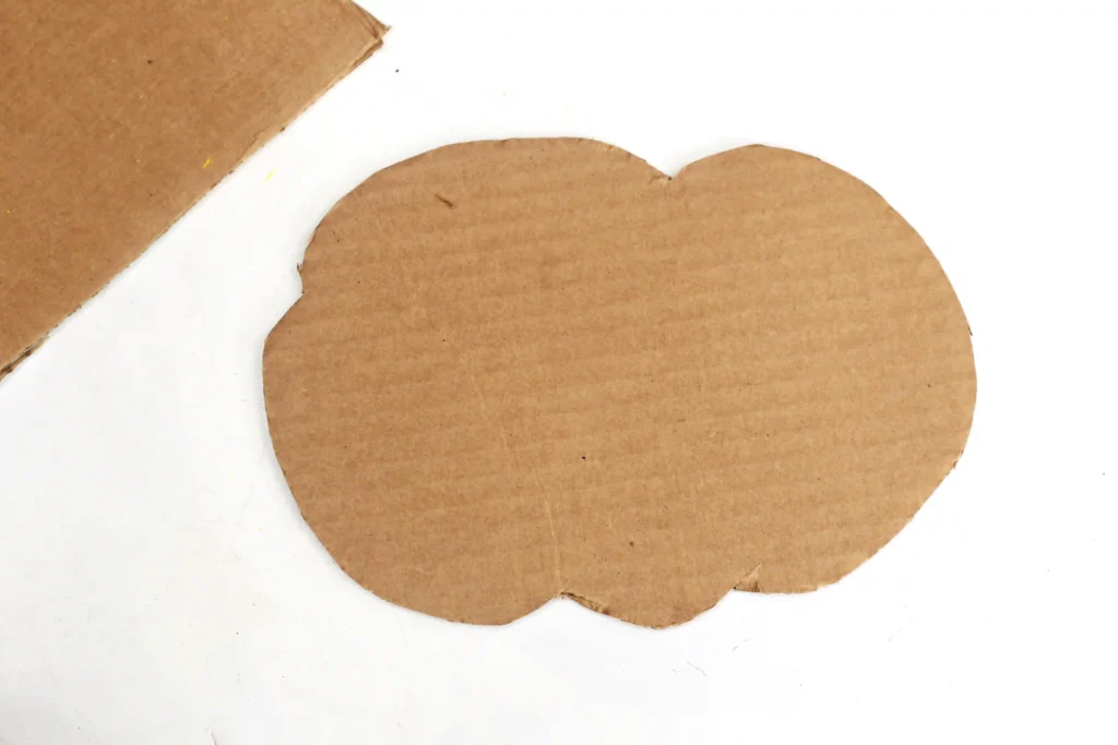 a piece of cardboard cut into the shape of a cloud for this preschool math activity