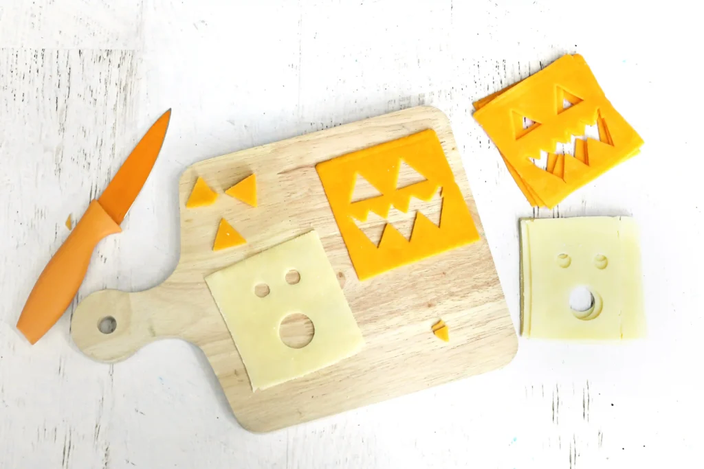 cheese slices with ghost and jack-o-lantern faces