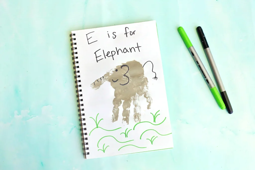 Letter E Elephant Handprint Craft - Cultivating Brilliant Minds a letter e handprint craft that is a grey handprint with details to look like an elephant