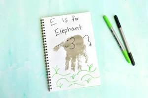 a letter e handprint craft that is a grey handprint with details to look like an elephant