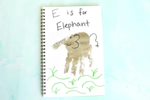 a letter e handprint craft that is a grey handprint with details to look like an elephant